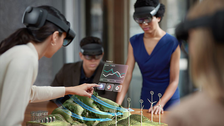 trois personnes qui travaillent avec des lunettes de réalité virtuelles